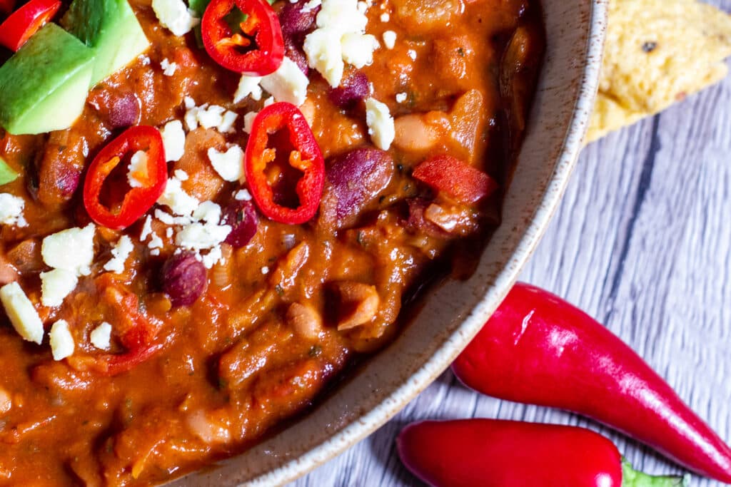 Close up of Slow Cooker Bean chilli showing mixed beans in sauce.