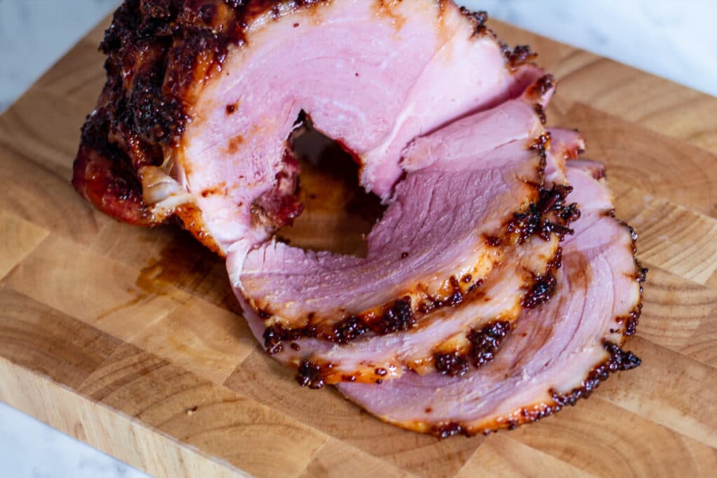 Picture of cooked and sliced Crockpot Gammon in Cola with honey and mustard glaze.