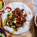 Over head image of slow cooked spciy beef tacos and salsa