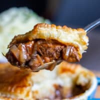A spoon of steak pie with pastry