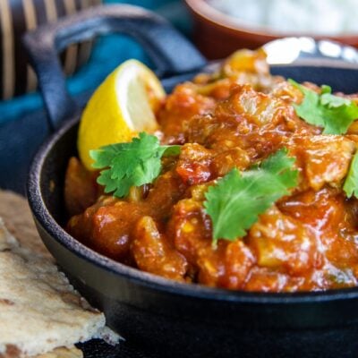 Side view of Slow Coker Chicken Bhuna with side dishes.