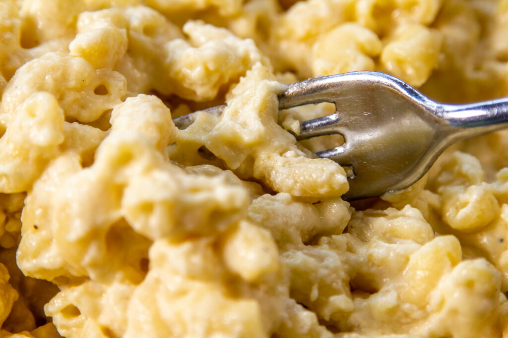 Closeup of mac and cheese with a silver fork