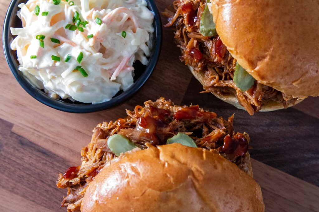 Overhead view of Crockpot Pulled Pork in brioche buns with coleslaw.