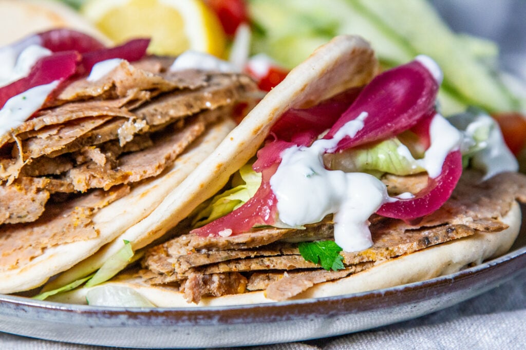 Slow Cooker Doner Kebab in a flatbread with salad and garlic dressing.