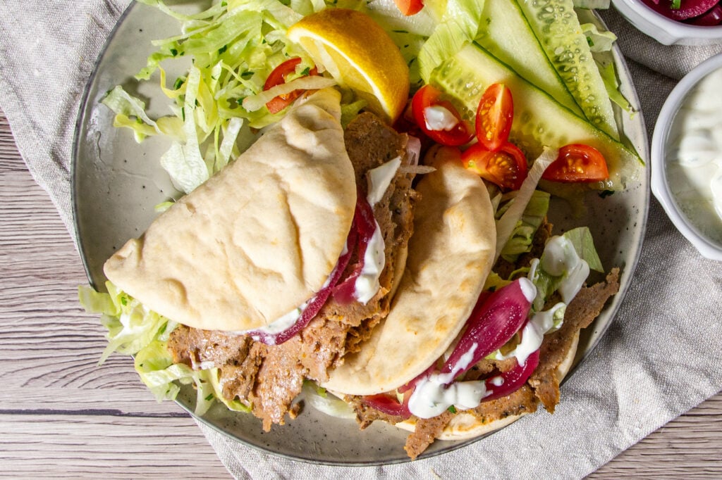Slow Cooker Lamb Doner Kebabs on a plate with salad.