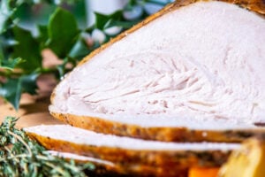 Image of Slow Cooker turkey crown which has been carved into slices.