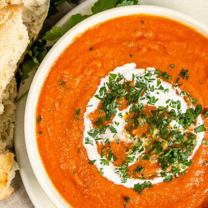 Overhead view of Slow Cooker Tomato Soup in a bowl with bread.