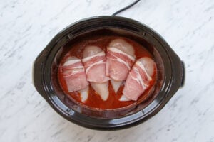 Chicken breasts wrapped in bacon in BBQ sauce.