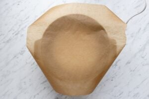 Picture to show how to measure the amount of baking parchment required to line a slow cooker.