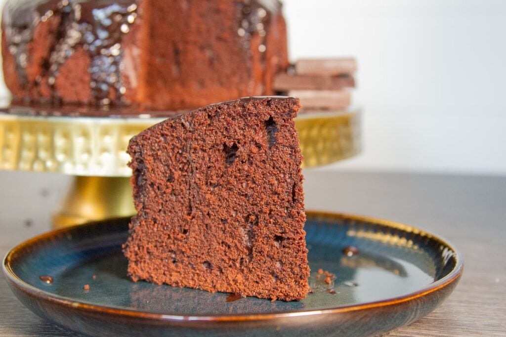 View of a slice of slow cooker chocolate cake which has been presented on a plate.