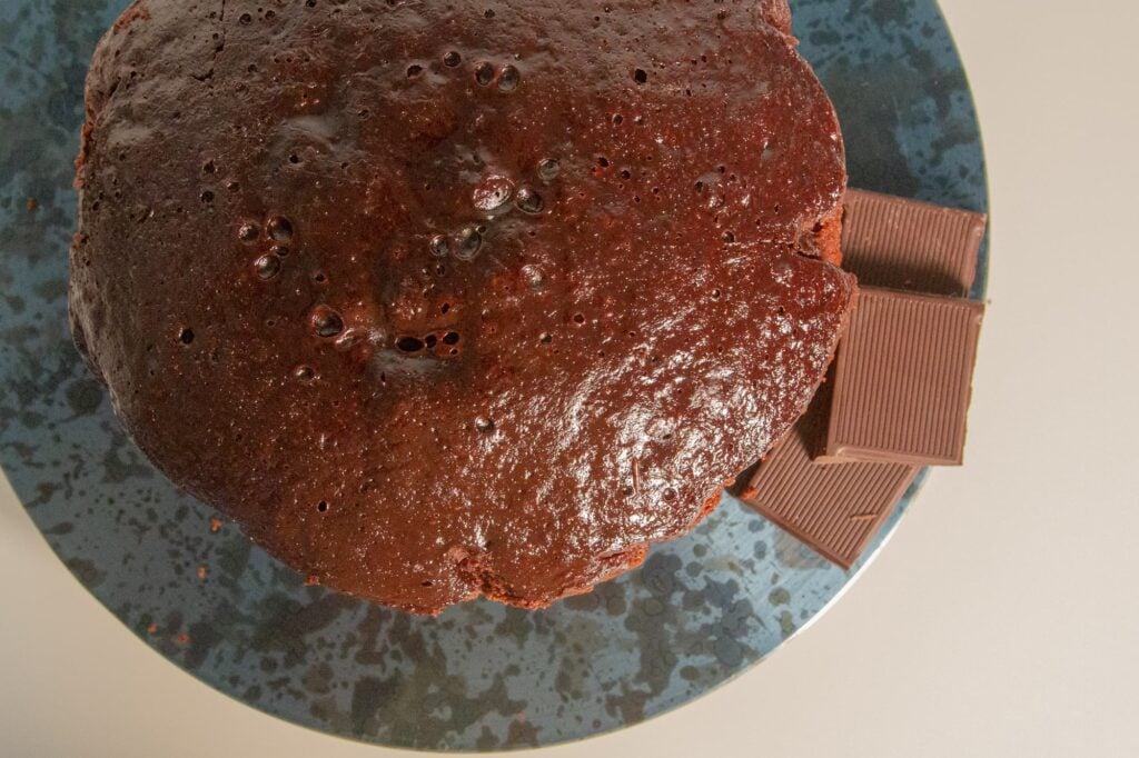 Overhead view of a chocolate cake that has been baked in the slow cooker.