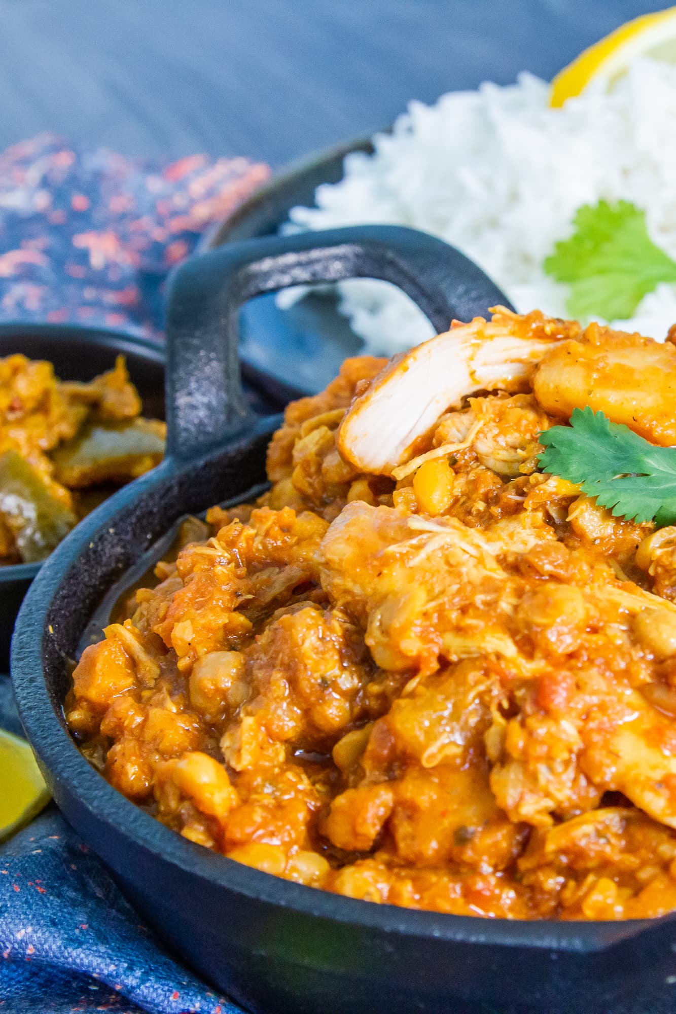 Close up view of chicken dhansak curry cooked in the slow cooker and served with rice and lime chutney.