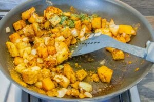 Image of frying vegetables and spices to make Chicken Dhansak in the slow cooker.