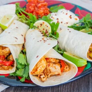 Slow Cooker Chicken Fajitas on a place with salsa and coriander.